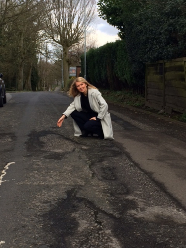 Esther McVey inspects a road with potholes in Cheshire East